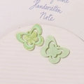 Macro shot of glittery light green acrylic butterfly charms for DIY shoe and jewelry crafts - Green