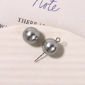 Macro shot of grey matte glass pearls with silver metal hooks on a white textured tray - Artificial Pearl (1 Piece) / 12mm / Gray