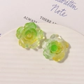 Detailed macro view of two translucent yellow-green resin rose charms with golden foil accents - Yellow & Green