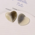 Macro detail of heart-shaped resin charms with gray and beige marble texture for DIY hair accessories - White Grey Marble