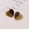 Detail of heart-shaped resin charms with brown tortoiseshell pattern on white tray - Yellow and Coffee Tortoiseshell