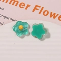 Detailed macro view of resin flower charms with glitter and solid green finish for DIY crafts - Lake Green