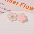 Macro shot of glittery resin flower charms in translucent and solid pink for DIY crafts - Pink