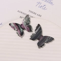 Detailed macro of ink-wash marble butterfly acrylic charms with glitter for DIY jewelry - Aurora Green