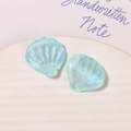 Macro view of light blue pearlescent shell-shaped acrylic charms for DIY crafts - Light Blue