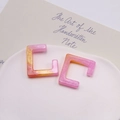 Dettaglio di ciondoli quadrati in resina con sfumatura glitterata rosa e arancione - Arancio Rosa
