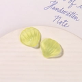 Detail of pearlescent yellow shell charms with glitter texture for DIY projects - Yellow-Green