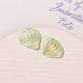 Macro detail of iridescent light green shell charms with pearlescent finish for DIY crafts - Light Green