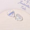 Macro shot of iridescent pearlescent shell charms with radiant texture for DIY crafts - Aurora White