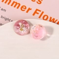 Details von rosa DIY Schuhanhängern aus Harz mit Muscheln und getrockneten Blumen - Rosa