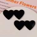 Dettaglio di accessori in acrilico a doppio cuore con finitura glitter nera per fai-da-te - Glitter Nero