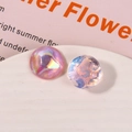 Vista macro di cabochon rotondi iridescenti con effetti glitter stellati scintillanti - Rosa Chiaro