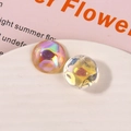 Macro shot of iridescent rainbow glass charms for DIY jewelry and headwear crafts - Orange