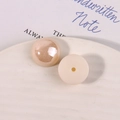 Macro detail of champagne pink half-round pearl beads with polished finish for DIY jewelry - Beige