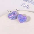 Macro detail of heart-shaped glitter resin accessories with purple and blue marble effect - Purple