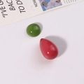 Close-up of vibrant red teardrop and green round resin beads for DIY earring making - Green Half-Round and Rose Red Waterdrop Set