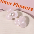 Close-up of pink marble texture acetate flower hair accessory with white pearl center - Purple