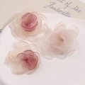 Close-up of layered mesh fabric flower petals in gradient pink and champagne colors - Pink