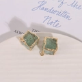 Macro detail of irregular gold-edged light green square resin stone charms for DIY jewelry - Green