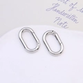 Close-up of dual silver oval spring snap hooks with polished finish for keychains - Silver