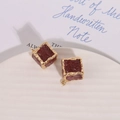 Detailed view of dark red resin cube pendants with textured gold-rimmed edges for jewelry - Chestnut