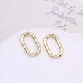 Detail of two oval gold-plated spring rings for DIY jewelry and keychain accessories - Gold