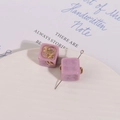 Detailed view of purple resin cube charms with gold mechanical gear inlays for DIY jewelry - Purple