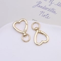 Close-up of heart-shaped gold alloy spring rings with 360-degree swivel lobster clasps - Heart Swivel Clasp / Gold
