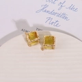 Macro detail of yellow translucent resin square charms with hammered gold metal edges - Yellow