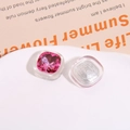Macro detail of square resin charms with pink crystal inlay for DIY jewelry and accessories - Rose Red