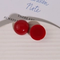 Macro shot of glossy red resin cabochon studs on a white plate for DIY jewelry making - Cabochon Flatback / 1 Piece / Dark Red