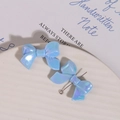 Macro detail of iridescent blue bow charms with metal link for DIY jewelry making - 1 Piece / Blue