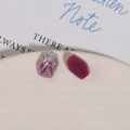 Macro detail of geometric resin earring studs with iridescent purple and rose glitter finish - Purple