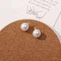 Detail view of round white imitation pearl pendants with gold metal rings for DIY jewelry - 12mm
