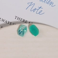 Detailed close-up of faceted mint green resin charms with sparkling glitter for DIY crafts - Lake Green