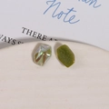 Close-up of faceted resin charms with holographic silver glitter and olive green matte texture - Army Green