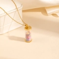 Detail of a gold glass bottle necklace filled with colorful heart-shaped natural stones - Multicolored Yellow Style (0839)