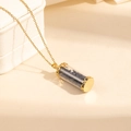 Detailed close-up of gold chain necklace with a blue stone filled glass vial pendant - Black Stone Style (0842)