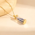 Detail of glass cylinder pendant with blue stones and golden filigree on a chain - Blue Stone Style (0844)