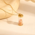Macro view of gold-plated cylinder glass pendant with orange-pink natural stones - Orange Stone Style (0845)