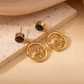 Detail van vintage gouden oorbellen met zon-sterpatroon en zwarte edelstenen - Zwarte Zirkonia Achtpuntige Ster Stijl (2008)