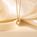 Detailed macro view of a gold necklace with irregular lava-style frame and a white pearl pendant - Geometric Artificial Pearl Pendant Necklace (0877)