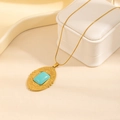 Detailed close-up of a vintage gold oval pendant necklace with a turquoise stone inlay - Oval Tag Square Turquoise Necklace (0889)