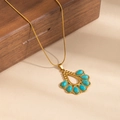 Detail of bohemian gold snake chain necklace with turquoise waterdrop pendant on wood - Hollow Water Drop Turquoise Necklace (0891)