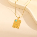 Detail of vintage gold rectangle pendant with embossed butterflies and blue stone inlay - Square Tag Butterfly Turquoise Necklace (0863)
