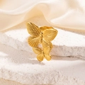 Exquisite gold stainless steel double butterfly ring on a white textured stone display - Two Butterflies Ring (R0039) / Gold