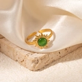 Detailed shot of golden sunflower ring with green gemstone on beige stone and silk fabric - Sunburst Green Cat's Eye Adjustable Style (TYR1037)