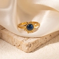 Detailed shot of golden sunflower ring with blue natural stone on silk background - Sunburst Blue Cat's Eye Adjustable Style (TYR1035)