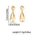 Detail shot of golden liquid metal teardrop earrings with dimensions 5.2cm by 1.6cm - Gold (EXRGE0932)