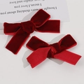 Close-up of elegant red velvet bow hair clips featuring premium textured ribbon detail - Burgundy